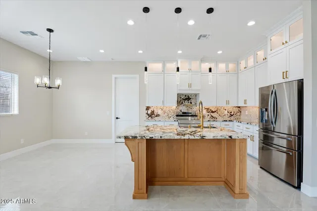 a kitchen with kitchen island a sink stainless steel appliances and window