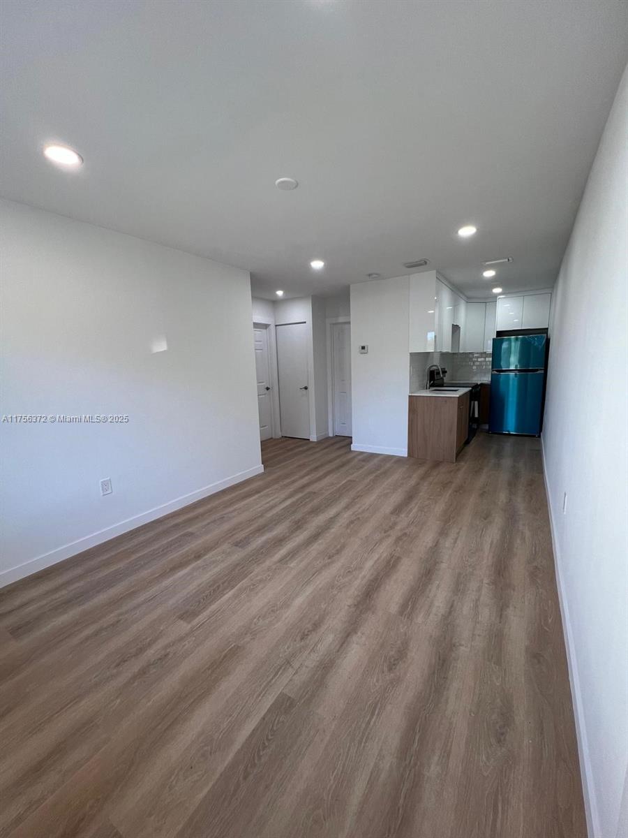 4227 Northwest 5th Street, Unit 8 Miami, FL 33126 - Photo 1 of 12 a view of a big room with wooden floor and windows