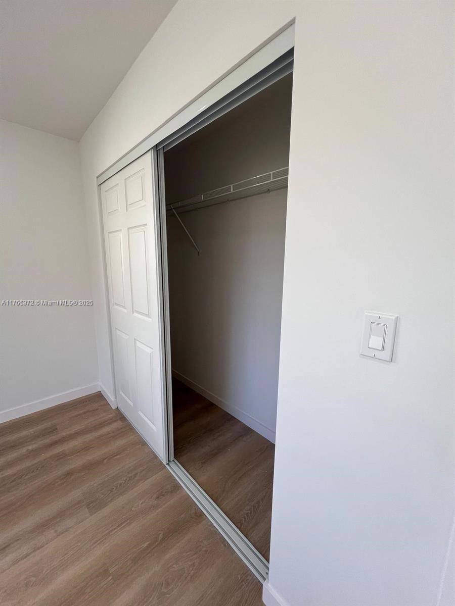 4227 Northwest 5th Street, Unit 8 Miami, FL 33126 - Photo 7 of 12 an empty room with wooden floor