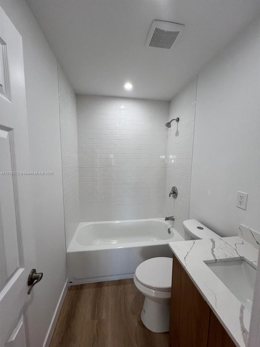 4227 Northwest 5th Street, Unit 8 Miami, FL 33126 - Photo 8 of 12 a bathroom with a sink a toilet and shower