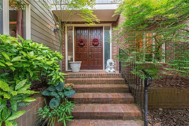a front view of a house with plants
