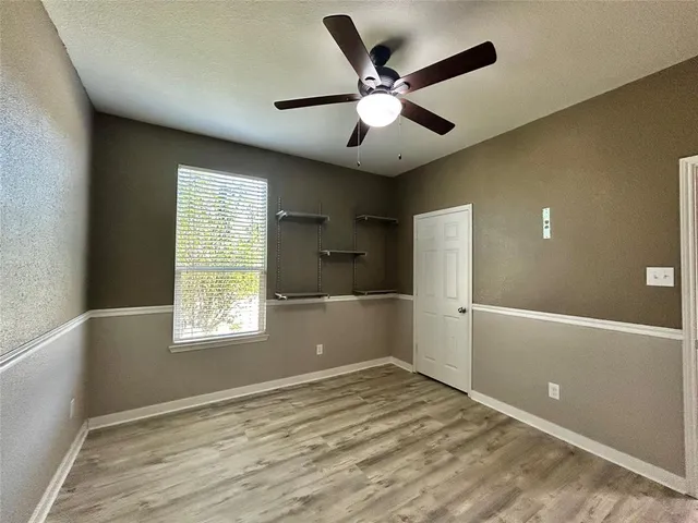 a view of a livingroom with a ceiling fan and window