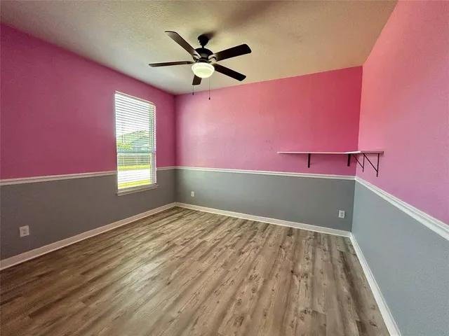 a view of a livingroom with a ceiling fan and window