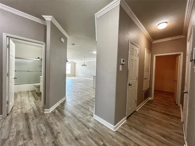 a view of a hallway with wooden floor