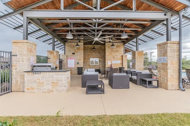 a living room with furniture and a ceiling fan