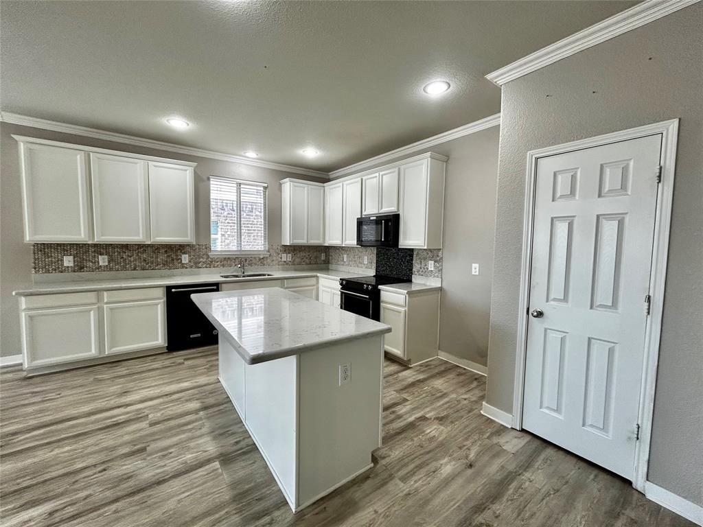 2336 Buelingo Lane Fort Worth, TX 76131 - Photo 4 of 27 a kitchen with a refrigerator a sink and cabinets