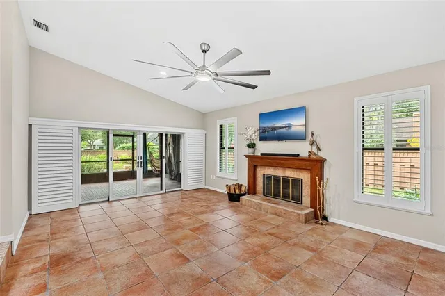 a kitchen with stainless steel appliances kitchen island granite countertop a dining table chairs and a refrigerator