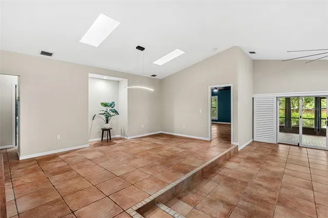 a kitchen with granite countertop white cabinets stainless steel appliances and a refrigerator
