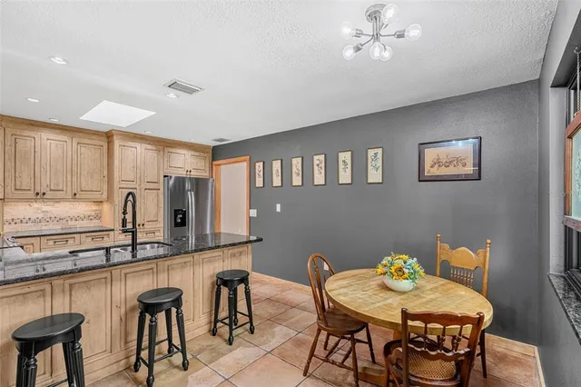 a kitchen with granite countertop a sink stainless steel appliances and cabinets
