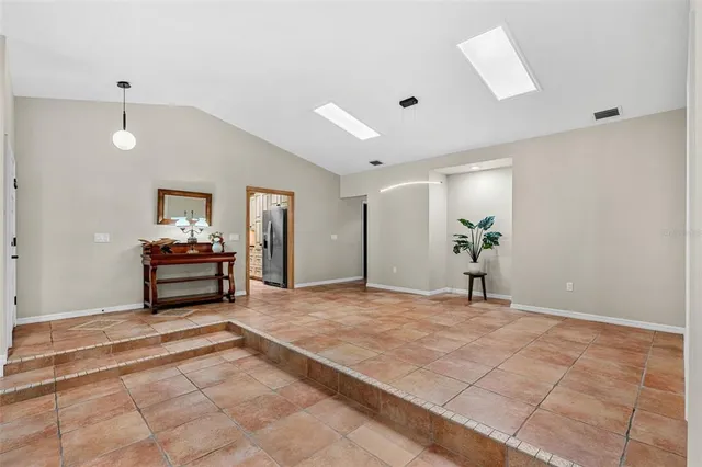 a bedroom with a large bed a flat tv screen and dresser