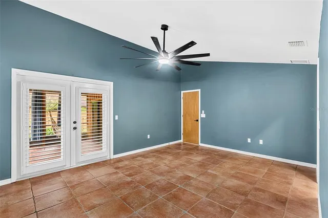 a view of a livingroom with a ceiling fan and window