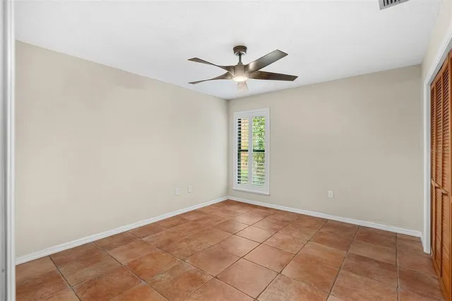 an aerial view of residential houses with outdoor space and trees