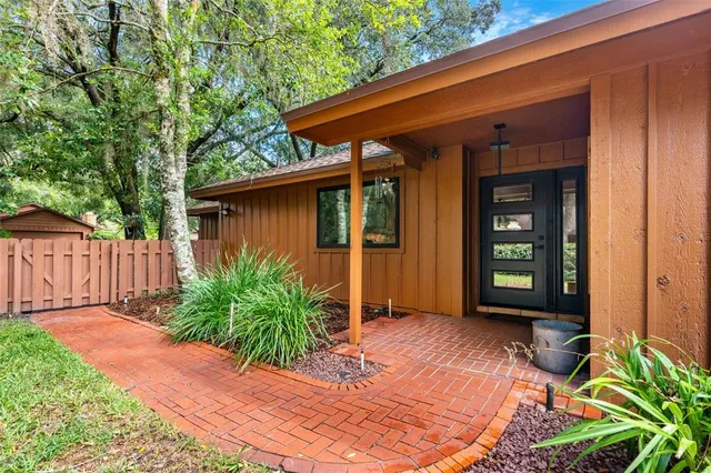 a view of a room with kitchen island dining table wooden floor and a view of kitchen