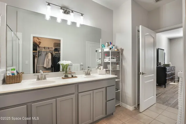 a bathroom with a sink double vanity and a shower