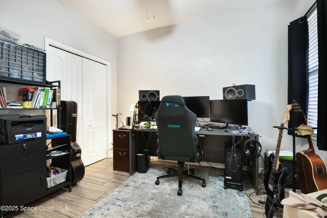 a view of a workspace with furniture and a window