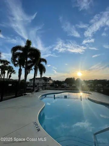a view of a swimming pool with an outdoor seating
