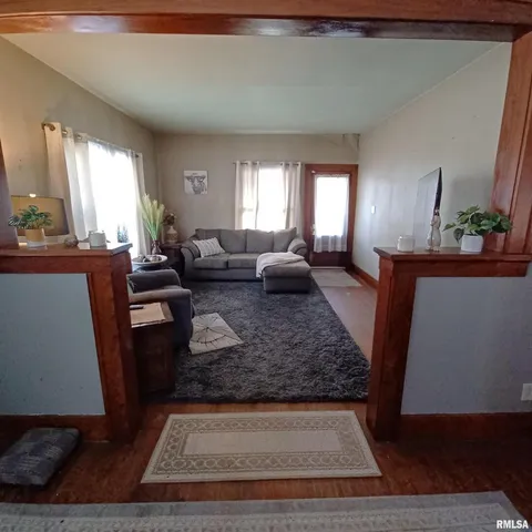 a living room with furniture rug and window