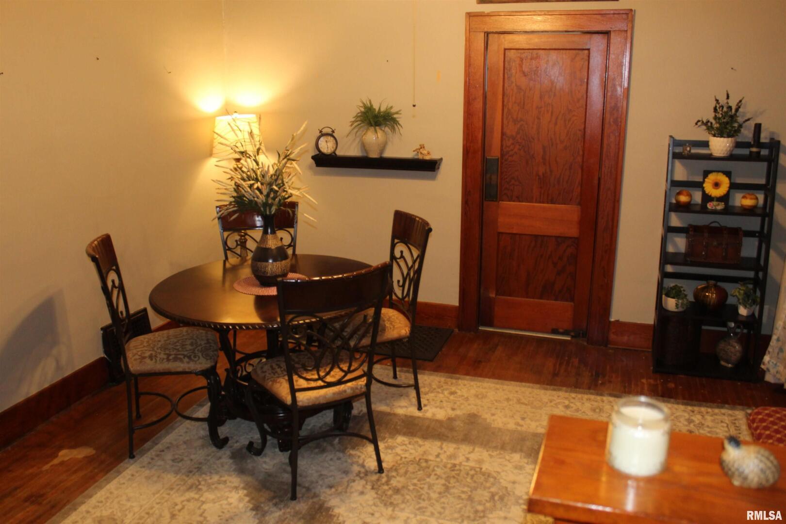 1208 Pine Street Kewanee, IL 61443 - Photo 22 of 36 a view of a dining room with furniture and wooden floor