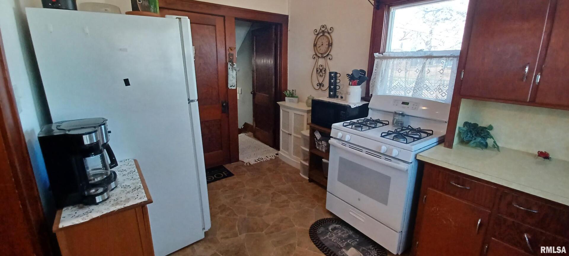 1208 Pine Street Kewanee, IL 61443 - Photo 25 of 36 a kitchen with a refrigerator stove and a window