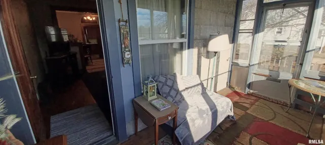 a balcony with table and chairs