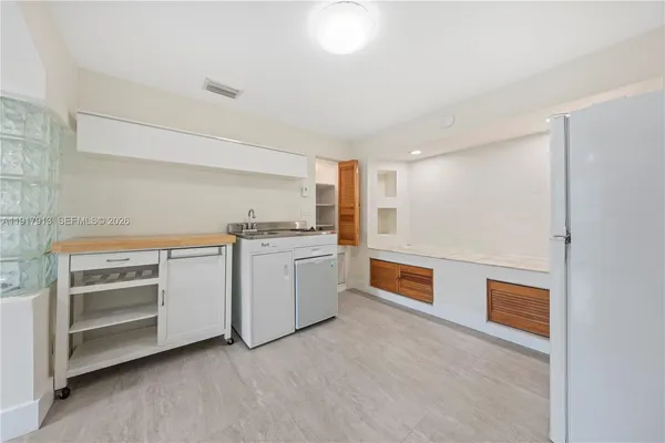 a kitchen with a stove and white cabinets