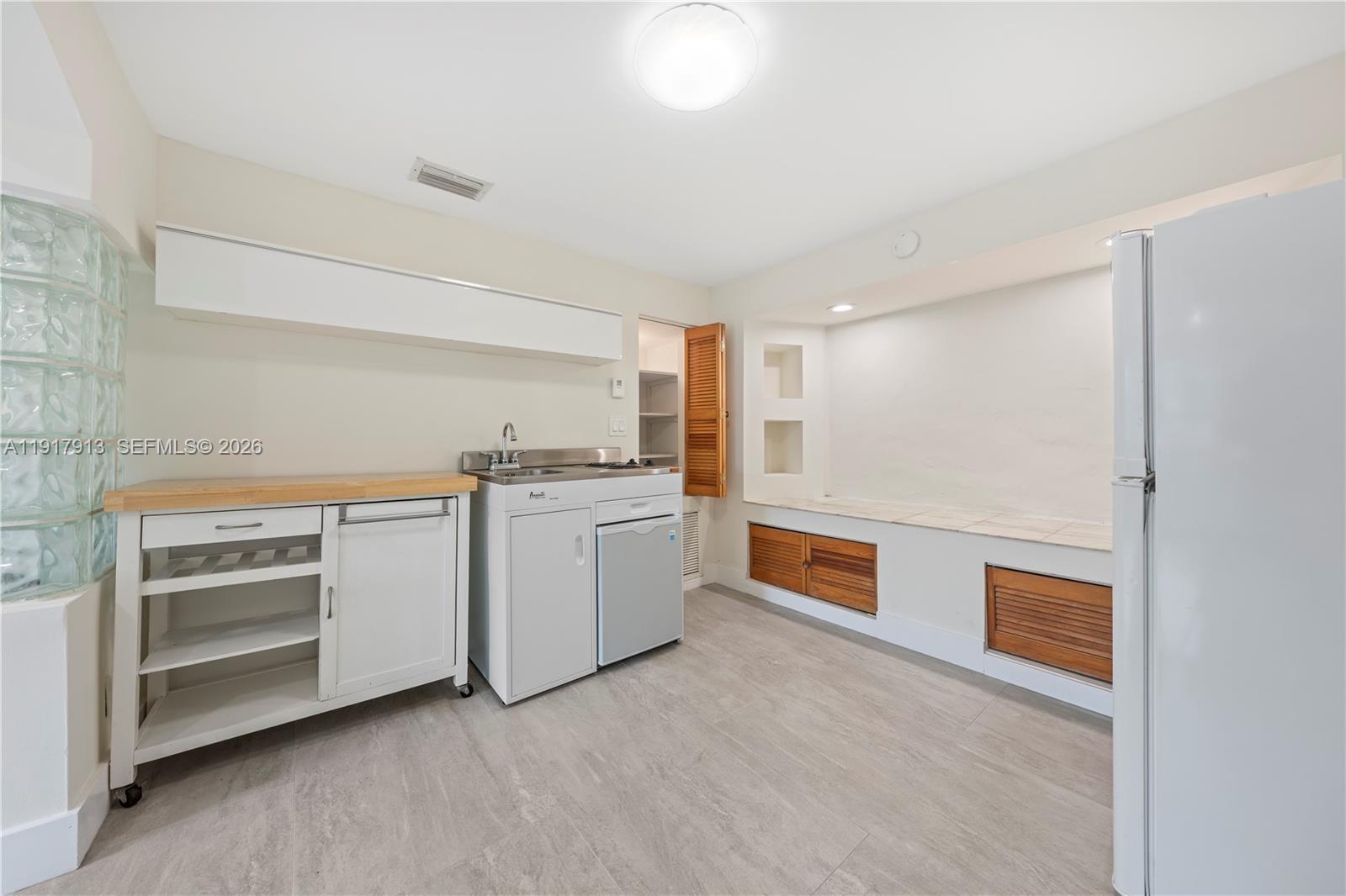 161 Southwest 52nd Court, Unit 161 Miami, FL 33134 - Photo 11 of 22 a kitchen with a stove and white cabinets