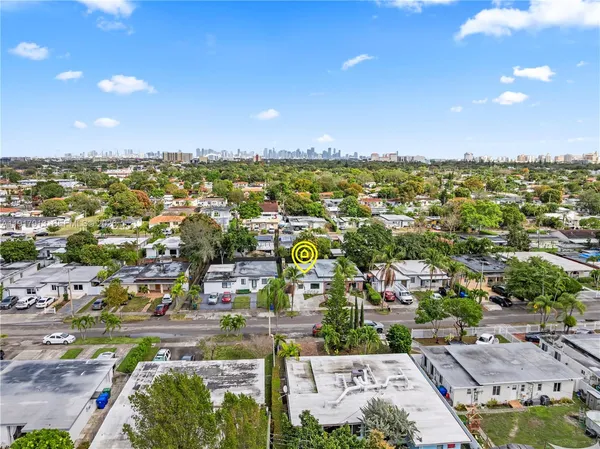 an aerial view of residential houses with city view