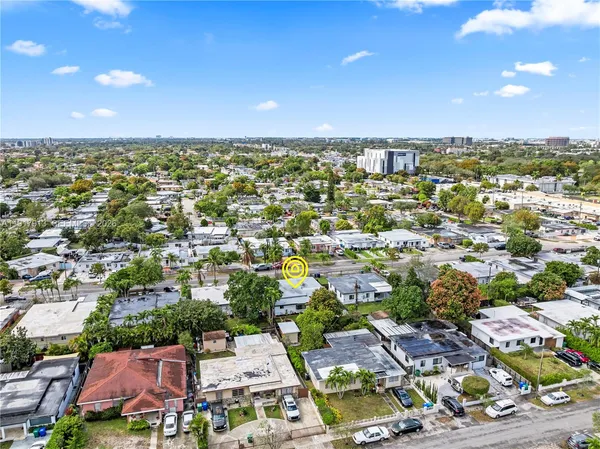 an aerial view of residential houses with city view