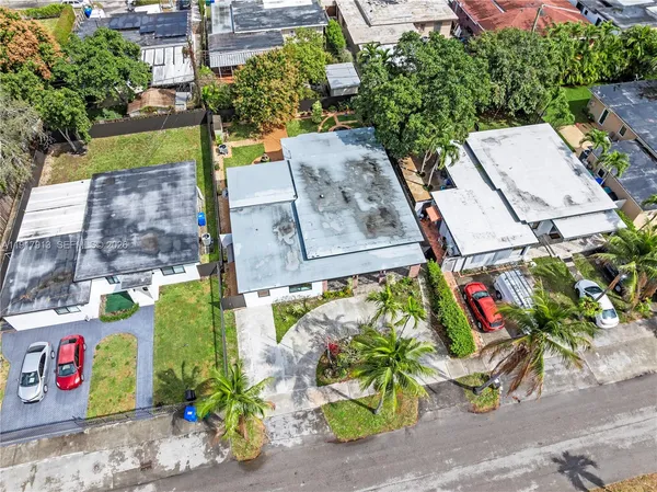 an aerial view of a house with a yard and garden