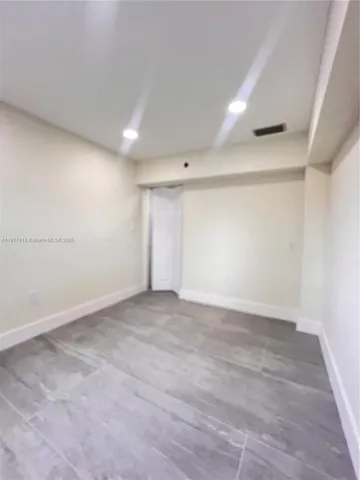 an empty room with wooden floor