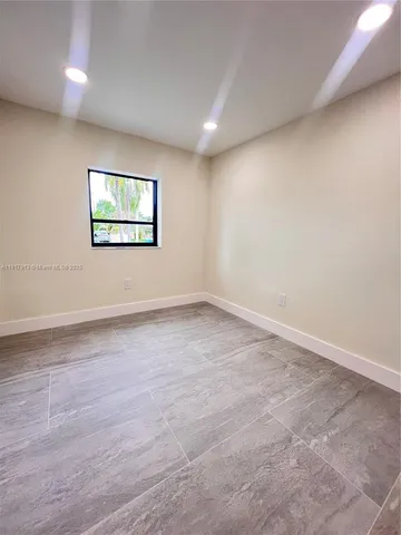 a bathroom with a glass shower door and a sink