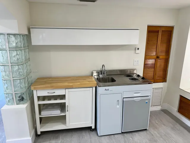 a kitchen with a stove and cabinets