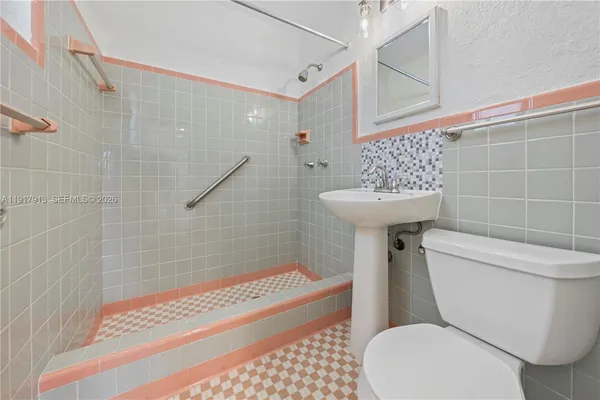 a bathroom with a toilet a sink and a shower