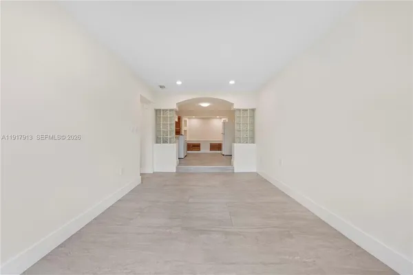 a view of a hallway with a bathroom