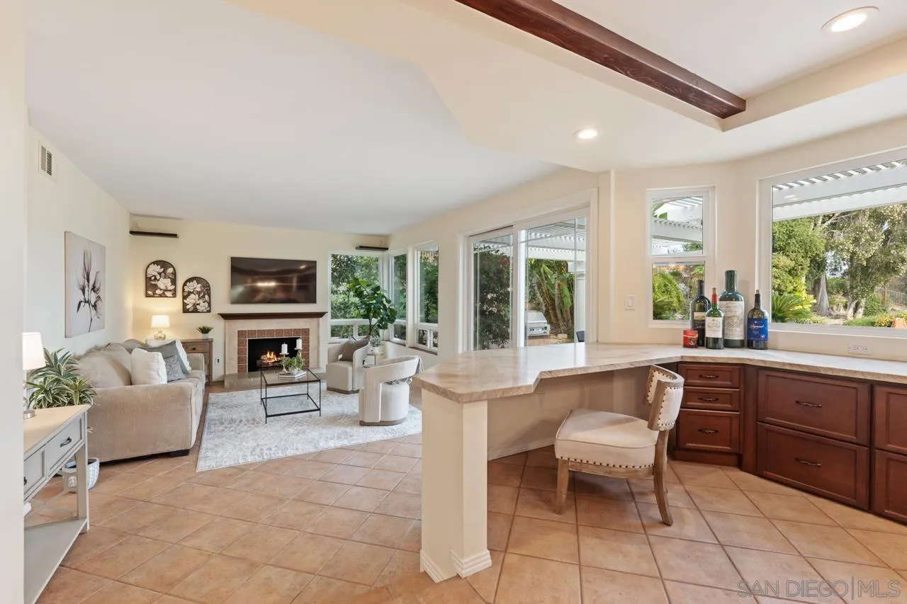 10235 Rue Chamberry San Diego, CA 92131 - Photo 27 of 72 a living room with furniture a fireplace and a table