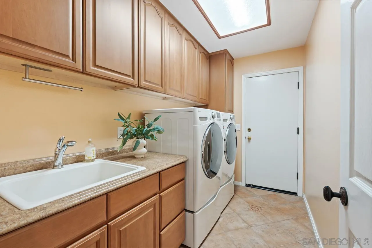 10235 Rue Chamberry San Diego, CA 92131 - Photo 31 of 72 a bathroom with a sink and a washer dryer