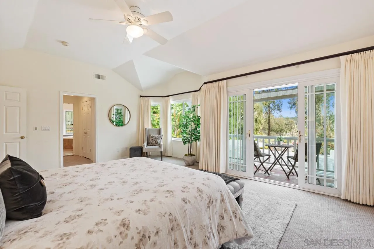 10235 Rue Chamberry San Diego, CA 92131 - Photo 34 of 72 a spacious bedroom with a large bed and a large window with the outer view