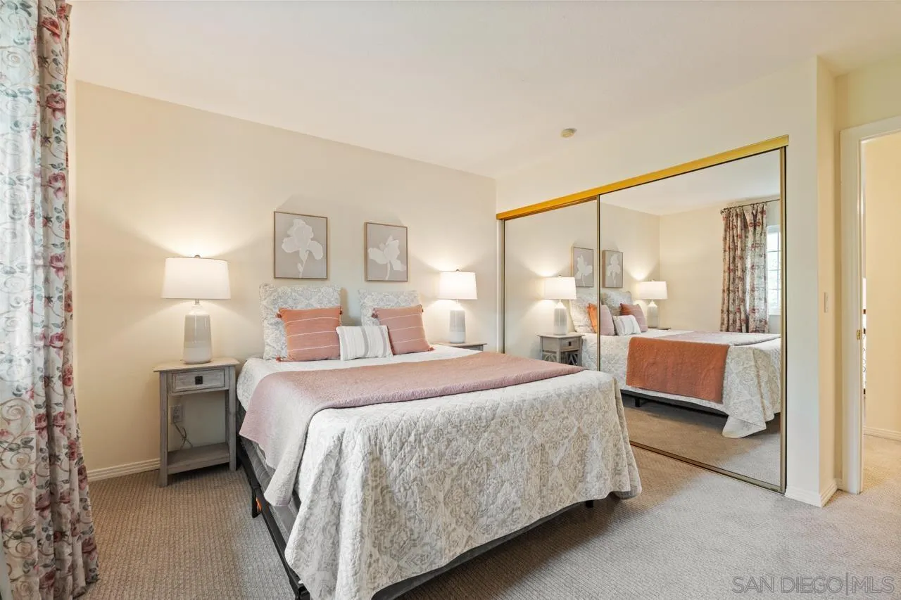 10235 Rue Chamberry San Diego, CA 92131 - Photo 41 of 72 a bedroom with a large bed and a couch next to a window