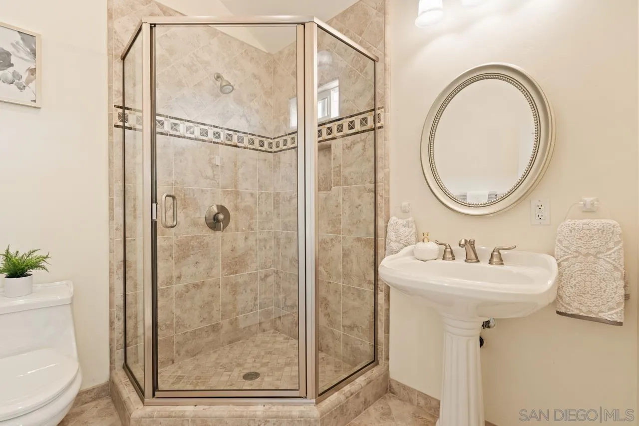 10235 Rue Chamberry San Diego, CA 92131 - Photo 45 of 72 a bathroom with a sink mirror toilet and shower