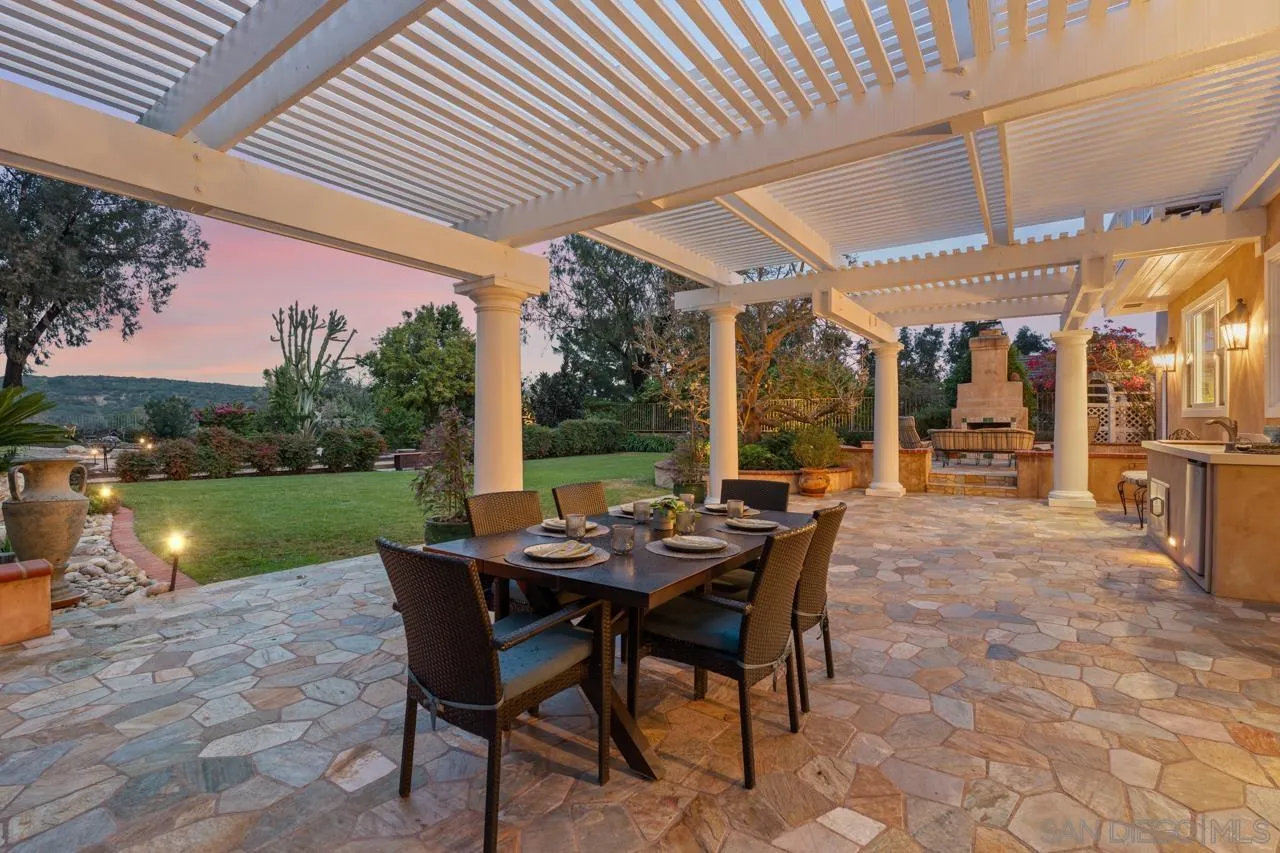 10235 Rue Chamberry San Diego, CA 92131 - Photo 7 of 72 a view of a patio with a table chairs and a backyard