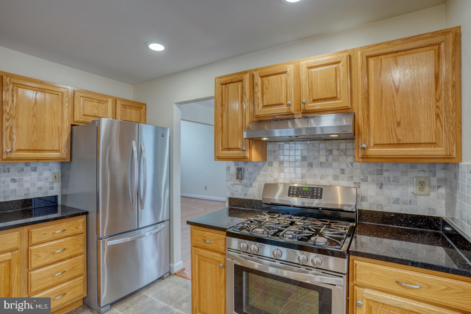 22 Arbor Drive Dover, DE 19904 - Photo 17 of 52 a kitchen with granite countertop cabinets stainless steel appliances and a counter space