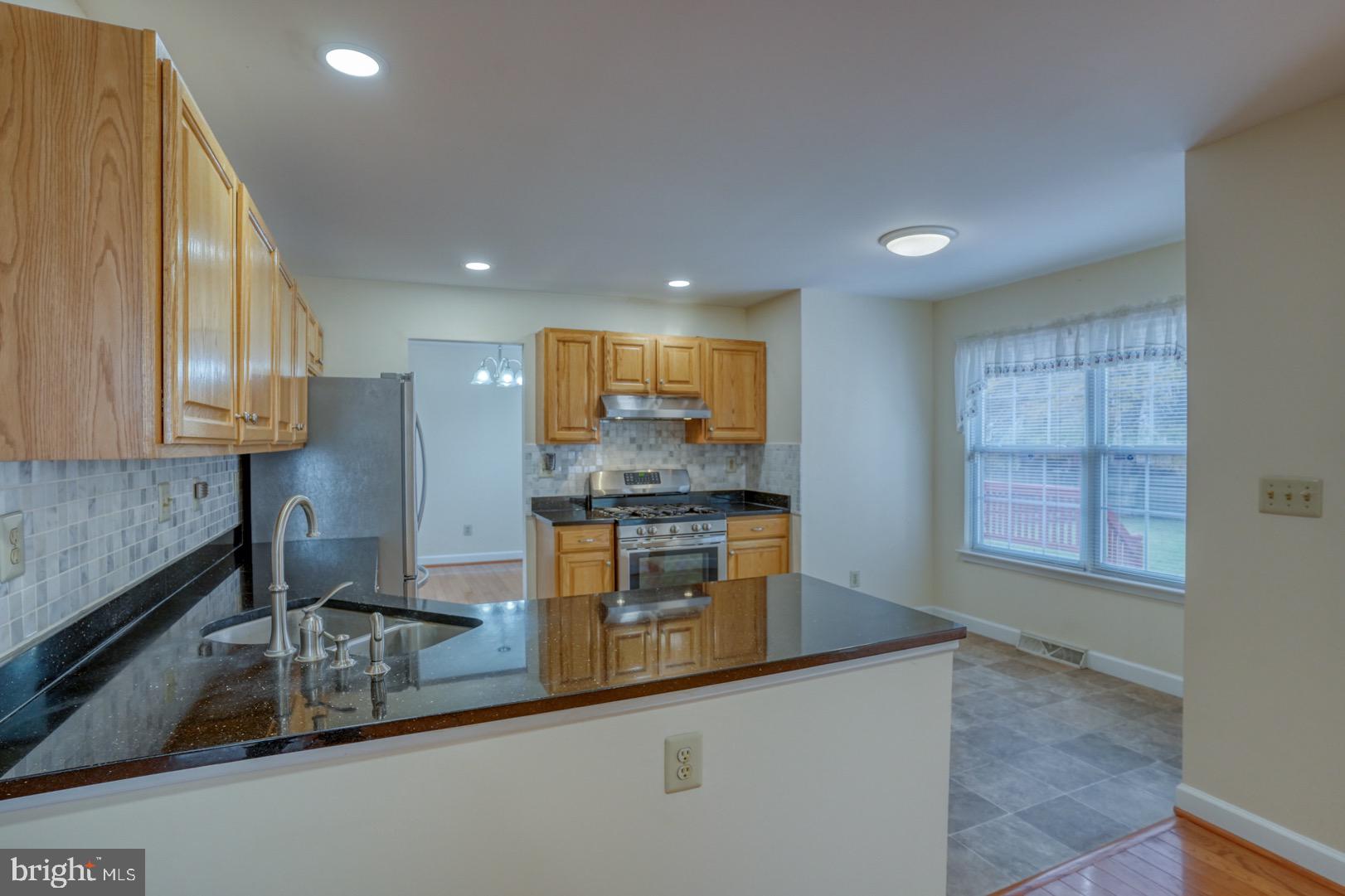 22 Arbor Drive Dover, DE 19904 - Photo 23 of 52 a kitchen with kitchen island granite countertop a sink window and stainless steel appliances