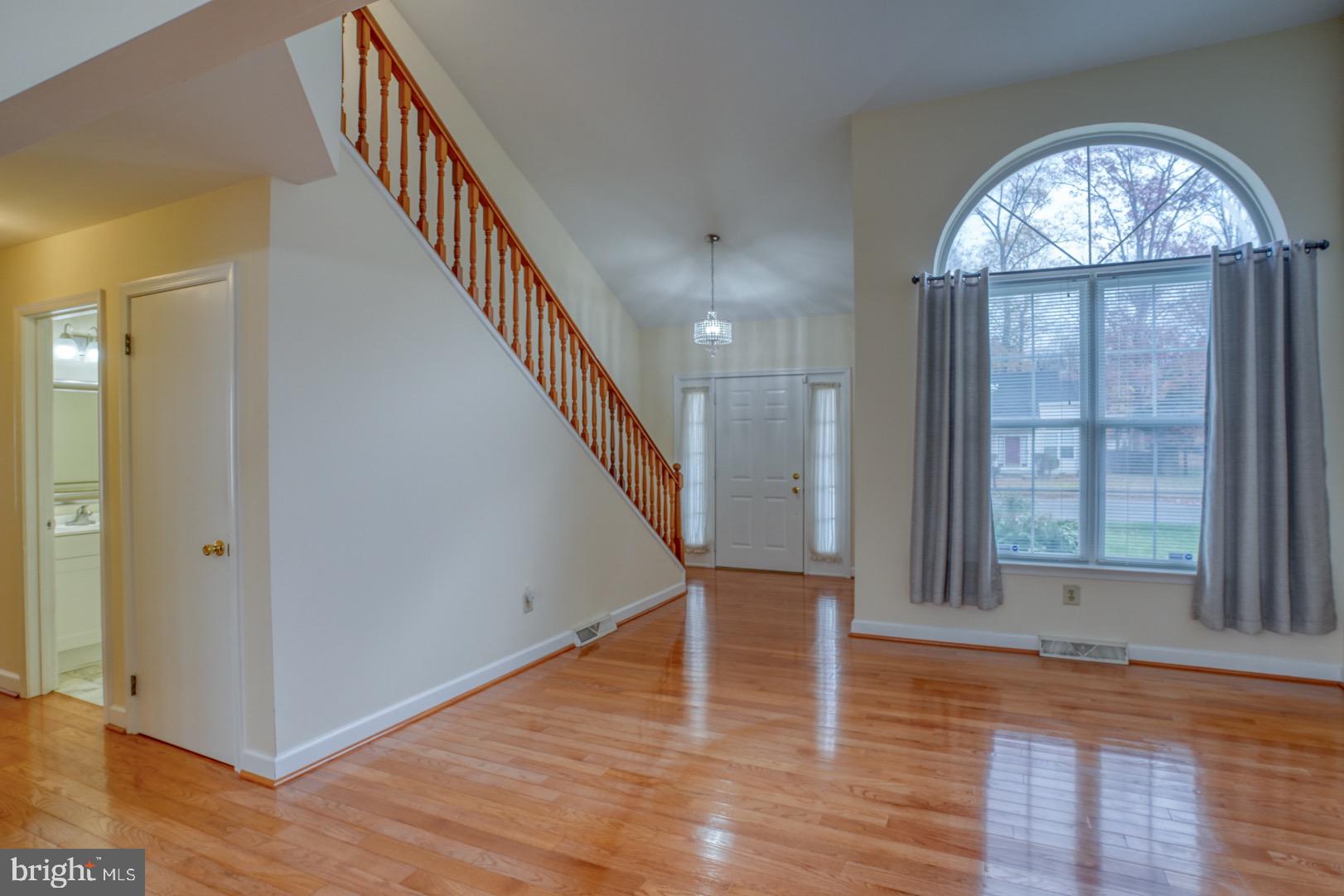 22 Arbor Drive Dover, DE 19904 - Photo 7 of 52 wooden floor in an empty room with a window and wooden floor