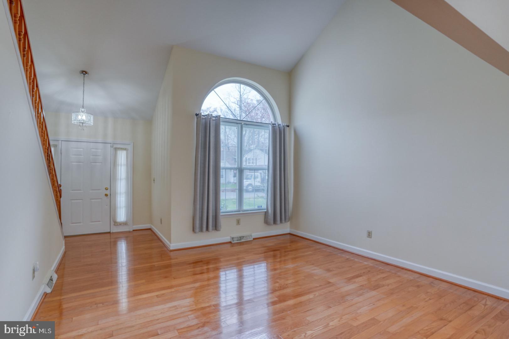 22 Arbor Drive Dover, DE 19904 - Photo 8 of 52 an empty room with wooden floor mirror and windows
