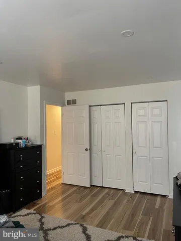 a view of an empty room and closet area