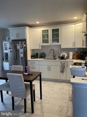 a kitchen with stainless steel appliances a sink a counter top space and cabinets