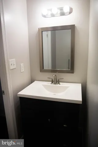 a bathroom with a sink vanity and a mirror