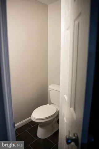 a white toilet sitting next to a shower