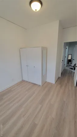 a view of a room with wooden floor