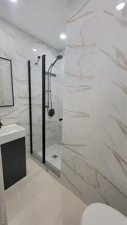 a bathroom with a toilet and a shower